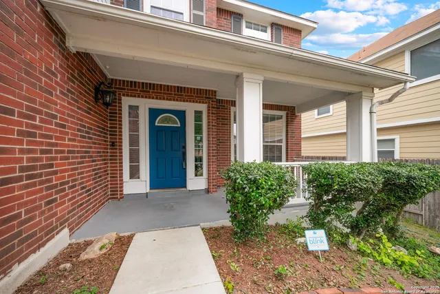 front view of a brick house with a large window
