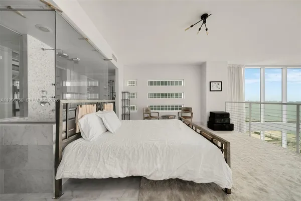 a kitchen with white cabinets and sink