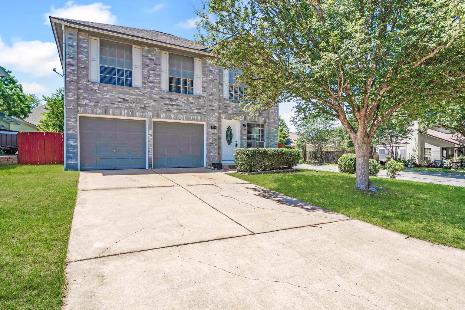 800 Smoke Signal Pass Pflugerville, TX 78660 - Photo 24 of 40 A well-maintained two-story home with a wide driveway and vibrant green lawn.