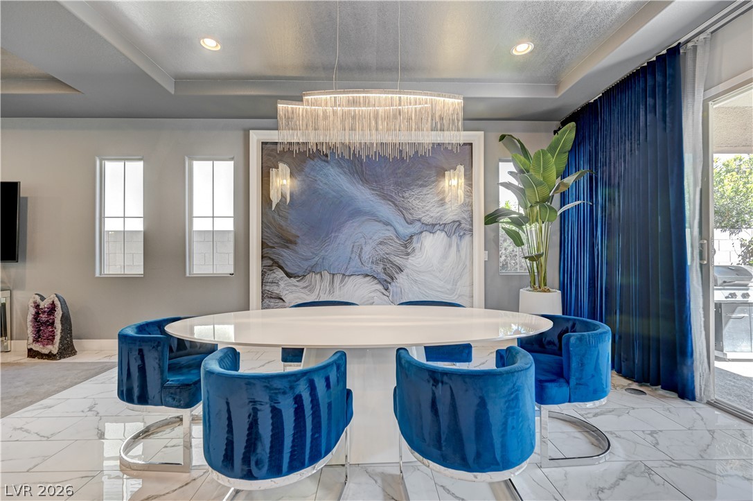 3943 Reyes Avenue Las Vegas, NV 89141 - Photo 12 of 95 Recessed lighting illuminates this dining area, complete with a contemporary tiered chandelier and tile flooring.