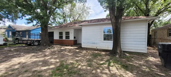 a view of a house with a tree in the yard