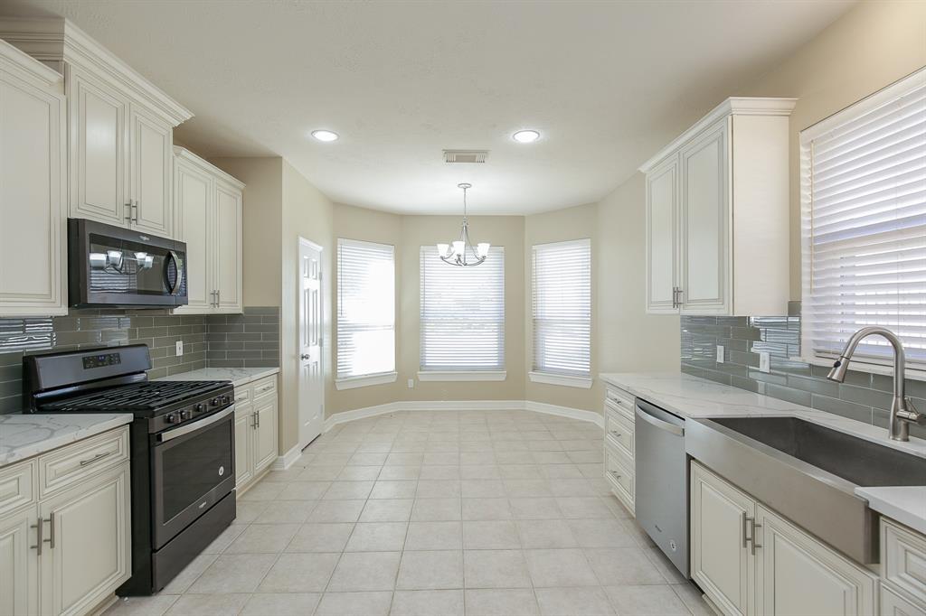 Great view of kitchen nook with bay windows for lots of natural light.