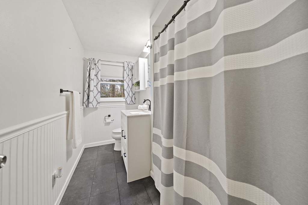 26 Wentworth Road Canton, MA 02021 - Photo 19 of 28 a bathroom with a sink and mirror with toilet