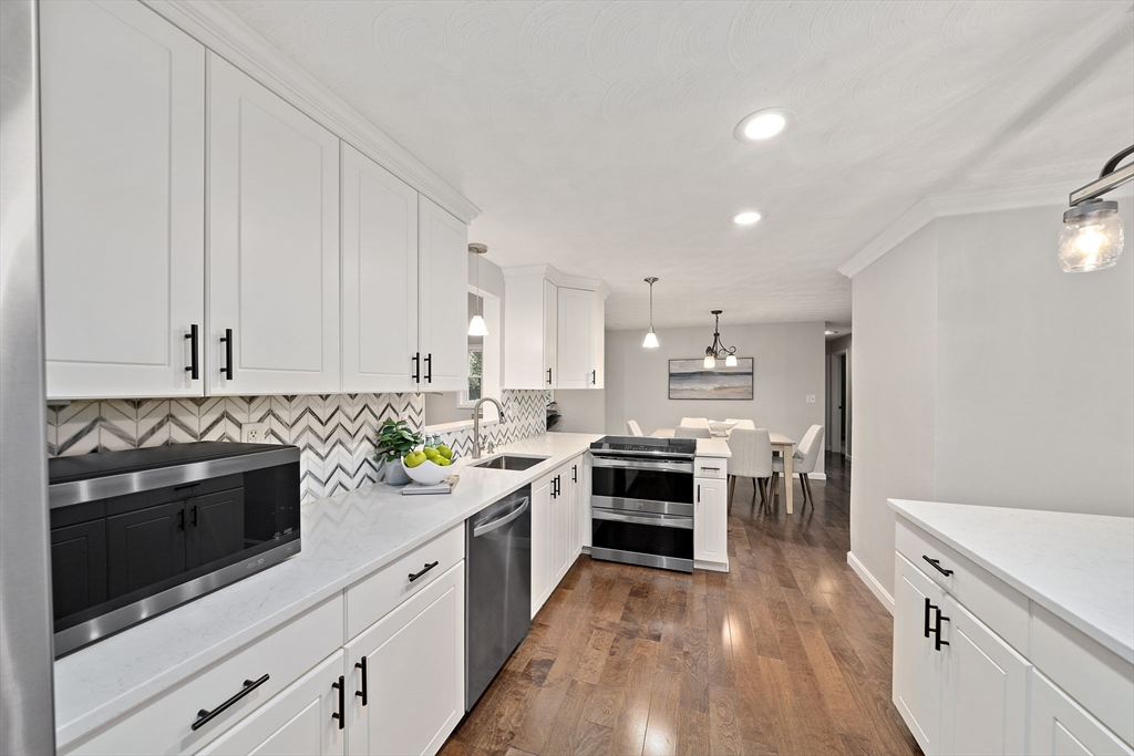 26 Wentworth Road Canton, MA 02021 - Photo 7 of 28 a kitchen with stainless steel appliances a stove a sink and a refrigerator