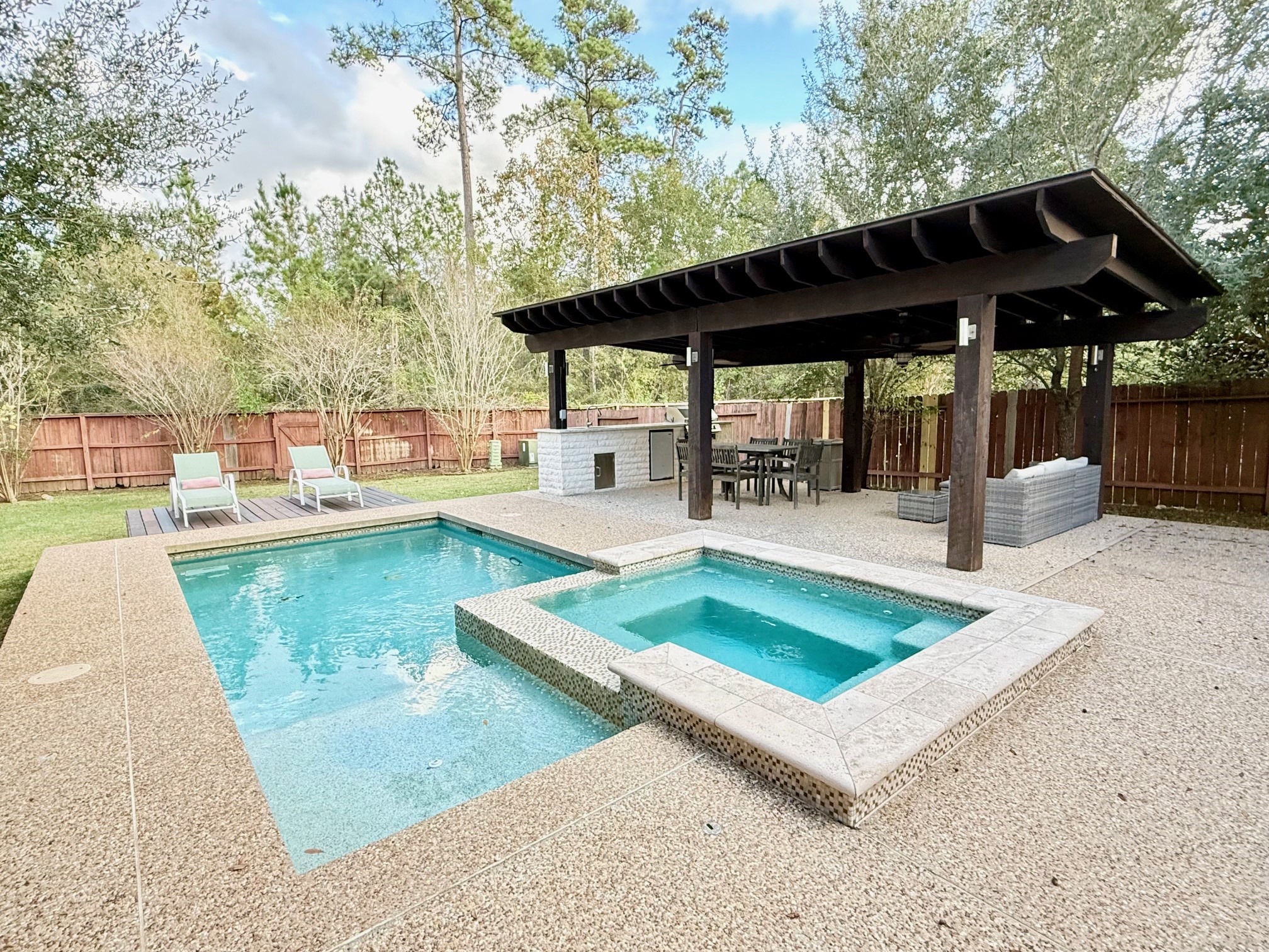 142 East Spindle Tree Circle The Woodlands, TX 77382 - Photo 1 of 37 a view of a swimming pool with a patio