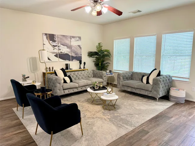a living room with furniture and a large window