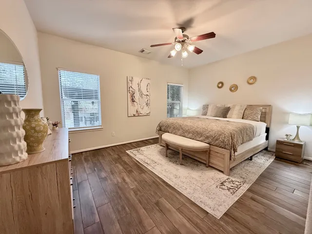 a bedroom with a large bed mirror and a window