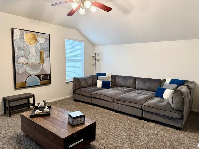 a living room with furniture and a night stand
