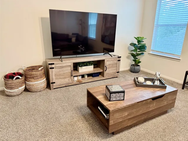 a living room with furniture and flat screen tv