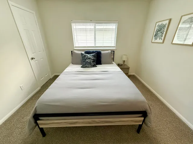 a bedroom with a bed and window