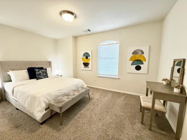 a bedroom with a bed and a window