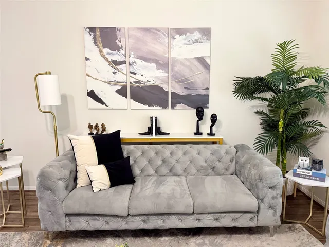 a living room with furniture and a potted plant