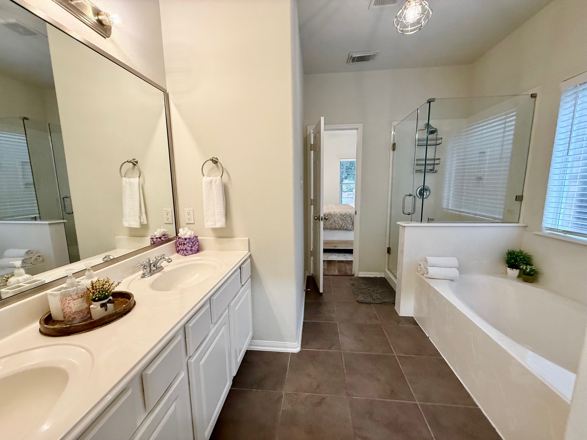 142 East Spindle Tree Circle The Woodlands, TX 77382 - Photo 21 of 37 a bathroom with a tub sink and mirror