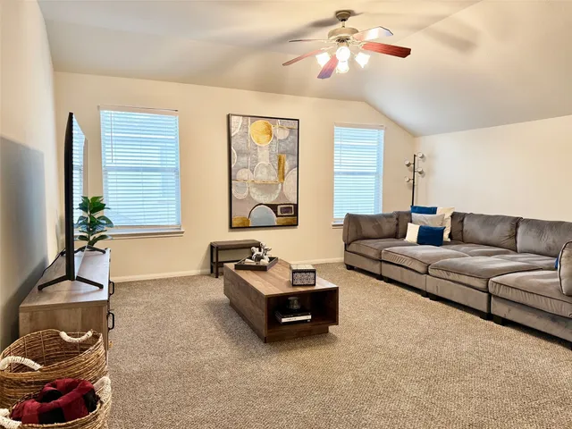 a living room with furniture and a potted plant