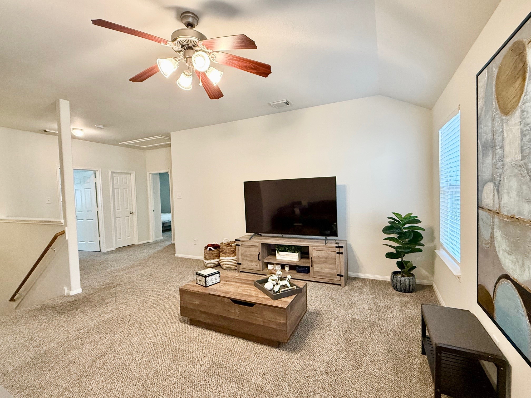 142 East Spindle Tree Circle The Woodlands, TX 77382 - Photo 32 of 37 a living room with furniture and a flat screen tv