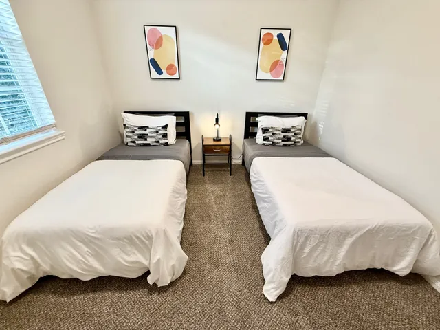 a bedroom with a bed and wall painting