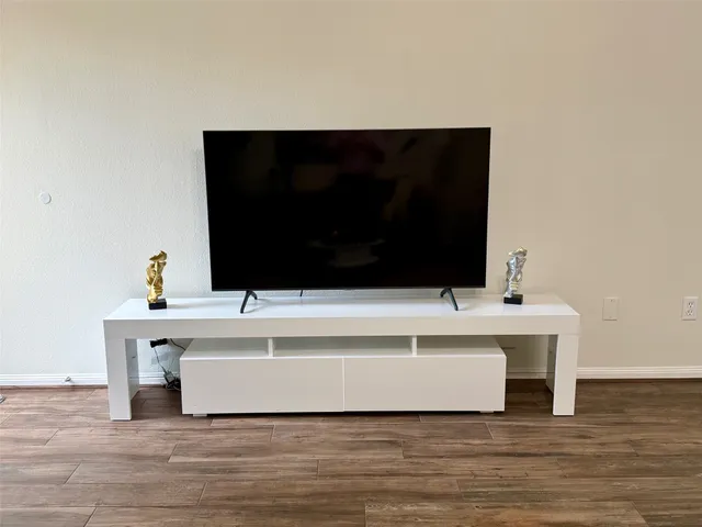 a living room with a flat screen tv and a fireplace