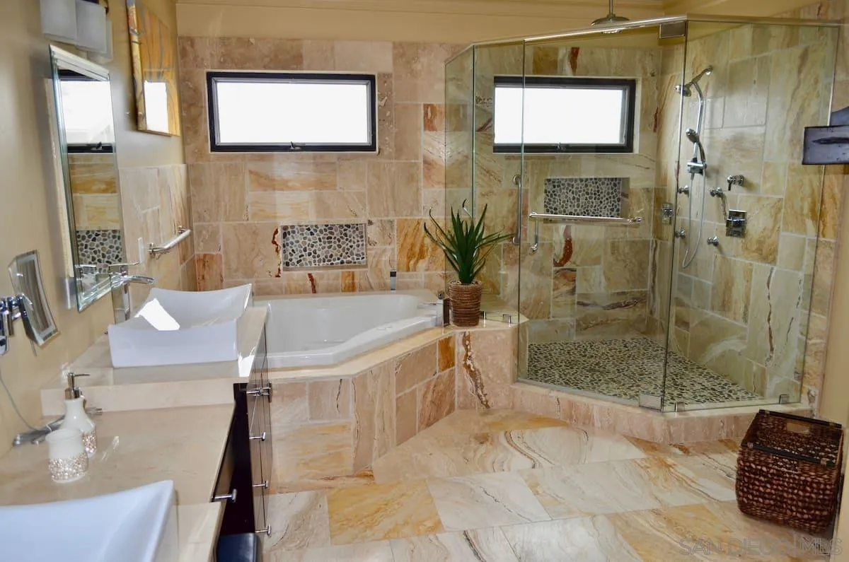1235 Neptune Avenue Encinitas, CA 92024 - Photo 28 of 32 a bathroom with a tub a mirror and a shower