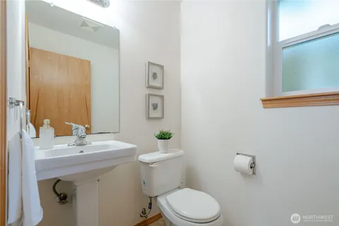 a bathroom with a sink a toilet and mirror