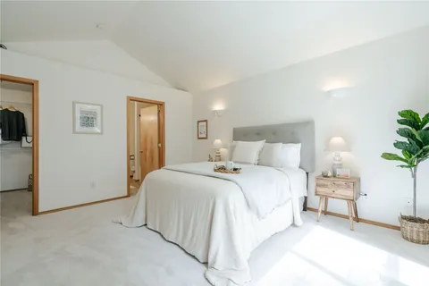a bed room with a bed and a night stand