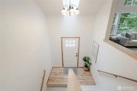 a view of a hallway to a livingroom with furniture