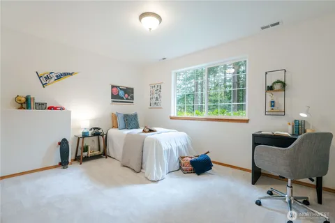 a spacious bedroom with a bed and a couch