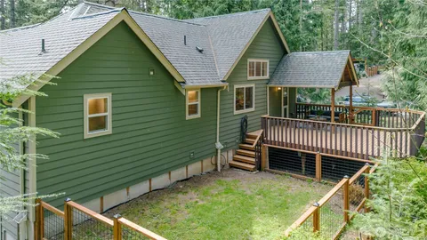 a backyard of a house with deck and furniture
