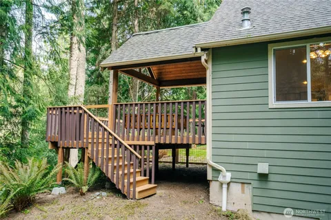 a view of backyard with deck and outdoor seating