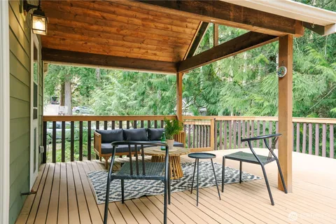 a view of a chairs and table in patio with a backyard