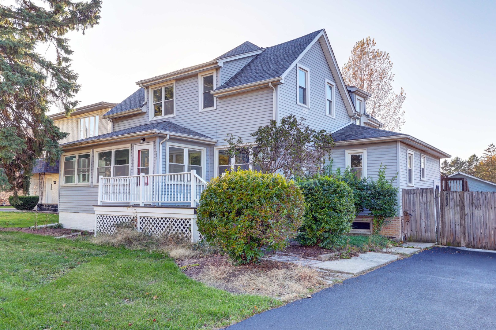 a front view of a house with a garden and plants