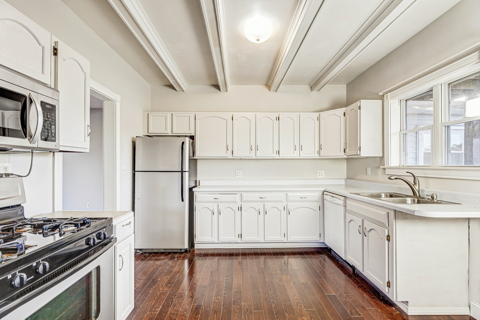 7832 Garden Lane Justice, IL 60458 - Photo 14 of 67 a kitchen with stainless steel appliances a stove a sink dishwasher a refrigerator and white cabinets with wooden floor