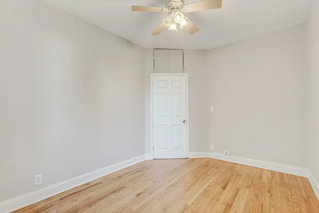 a bedroom with a bed and a ceiling fan
