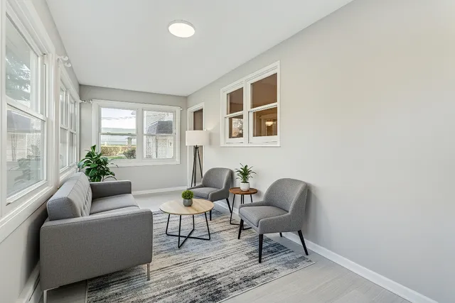 a living room with furniture and a potted plant
