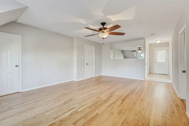 a view of house with deck and wooden floor