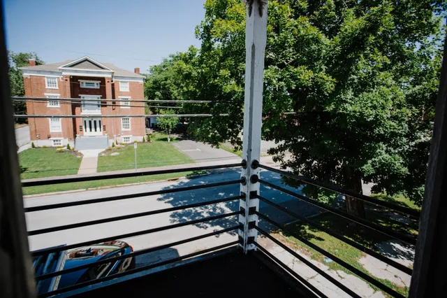 a view of a door and wooden floor