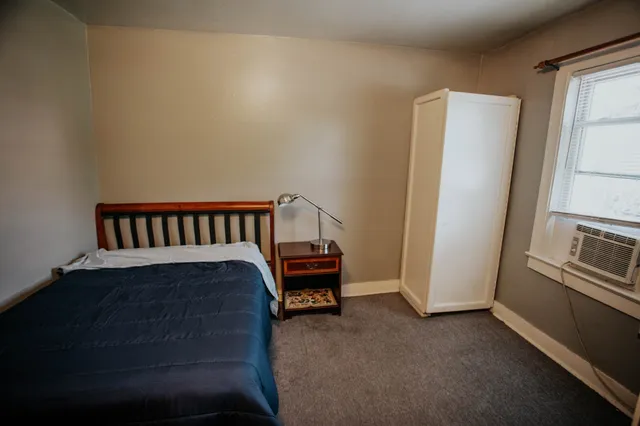 a kitchen with white cabinets and wooden floor