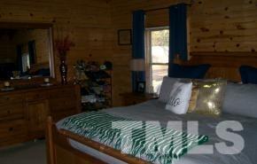 928 Dalrymple Road Cameron, NC 28326 - Photo 9 of 22 a bed sitting in a bedroom next to a window with kitchen view