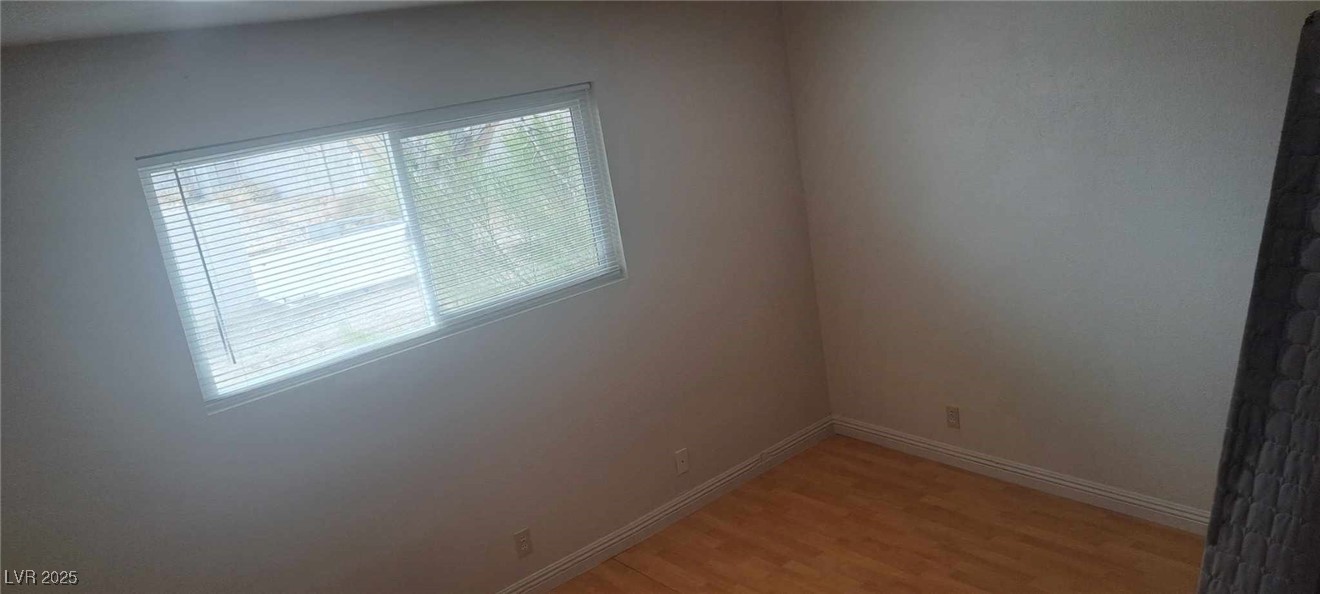 5231 Smoke Ranch Road Las Vegas, NV 89108 - Photo 14 of 23 Unfurnished room featuring light wood-style flooring and baseboards