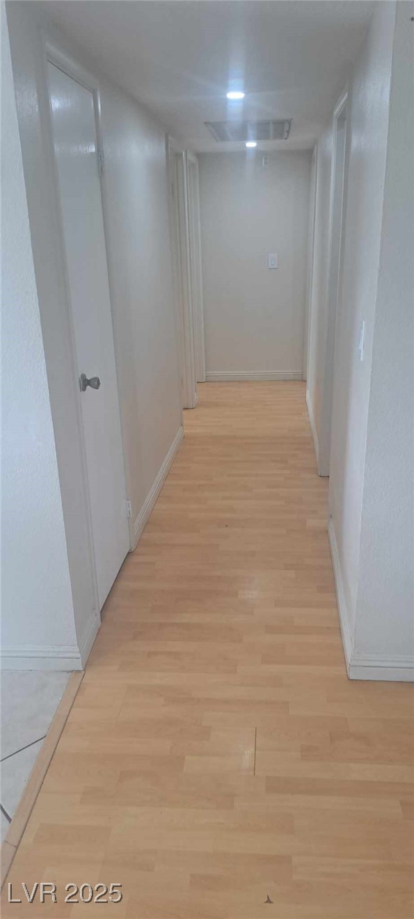 5231 Smoke Ranch Road Las Vegas, NV 89108 - Photo 15 of 23 Corridor with visible vents, light wood-style flooring, and baseboards