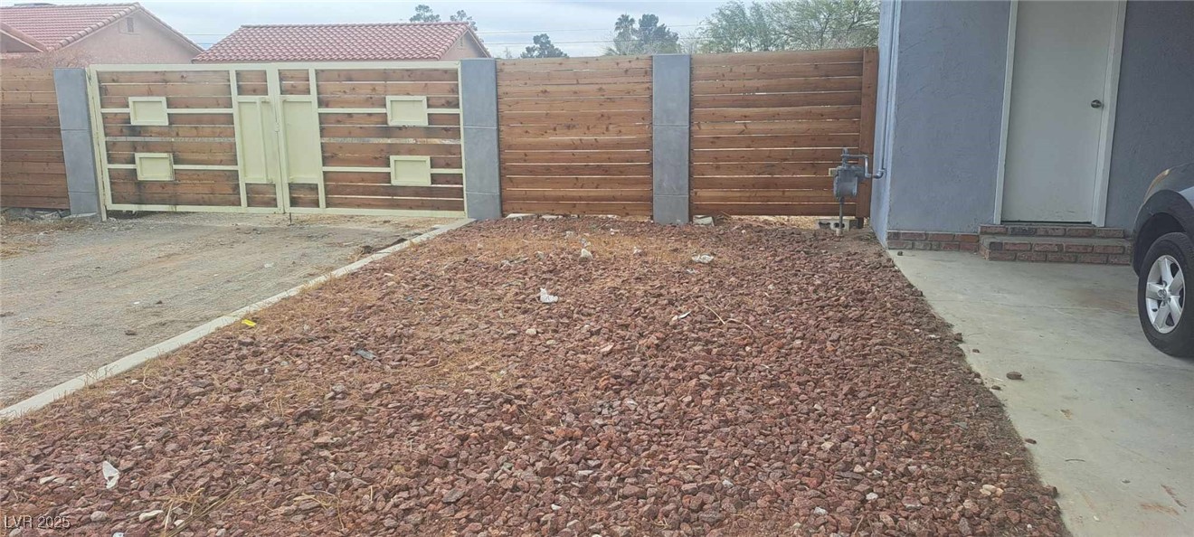 5231 Smoke Ranch Road Las Vegas, NV 89108 - Photo 20 of 23 View of yard with fence and a gate