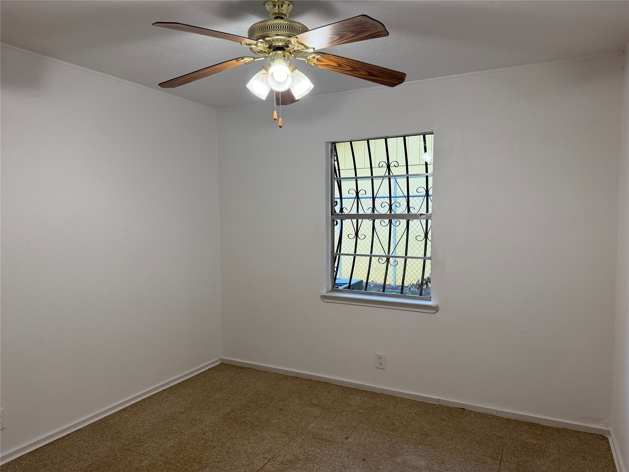 1060 Gardner Road Austin, TX 78721 - Photo 15 of 19 A well-lit room awaits your personal touch with a secure window and ceiling fan for comfort.