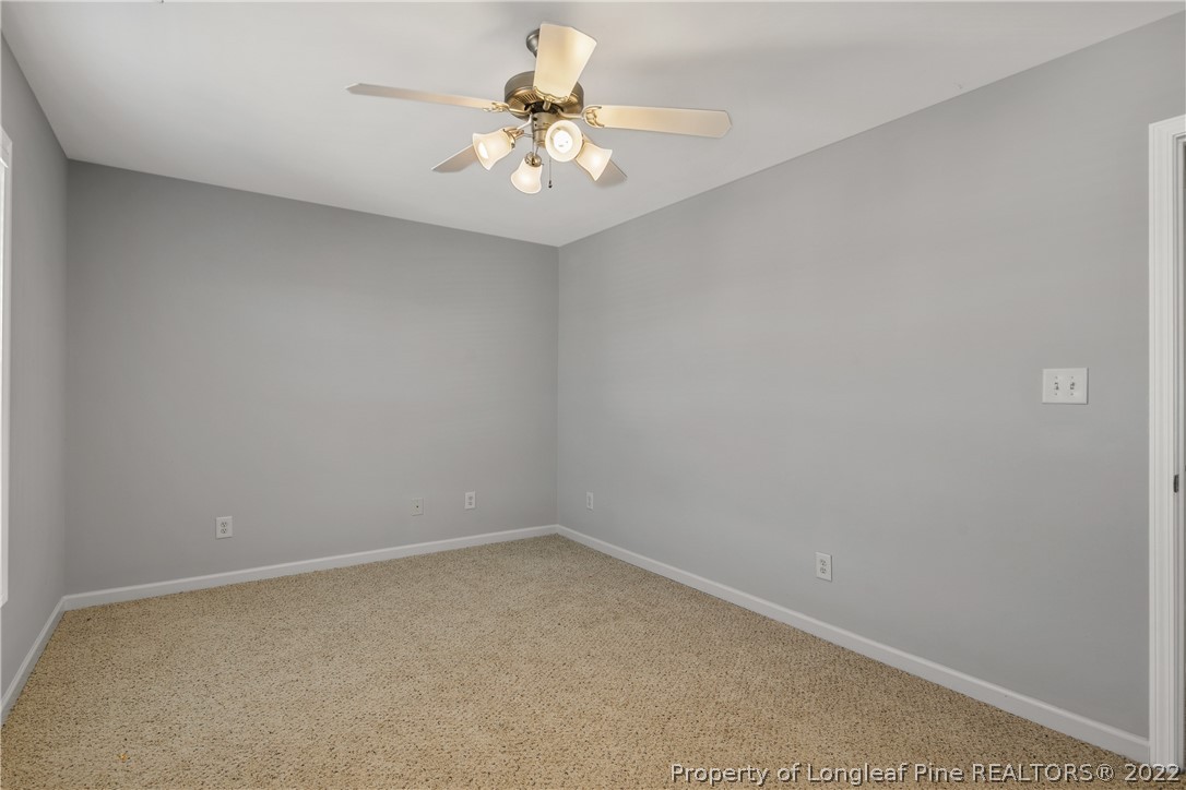 57 Pender Road Spring Lake, NC 28390 - Photo 35 of 50 an empty room with a chandelier fan