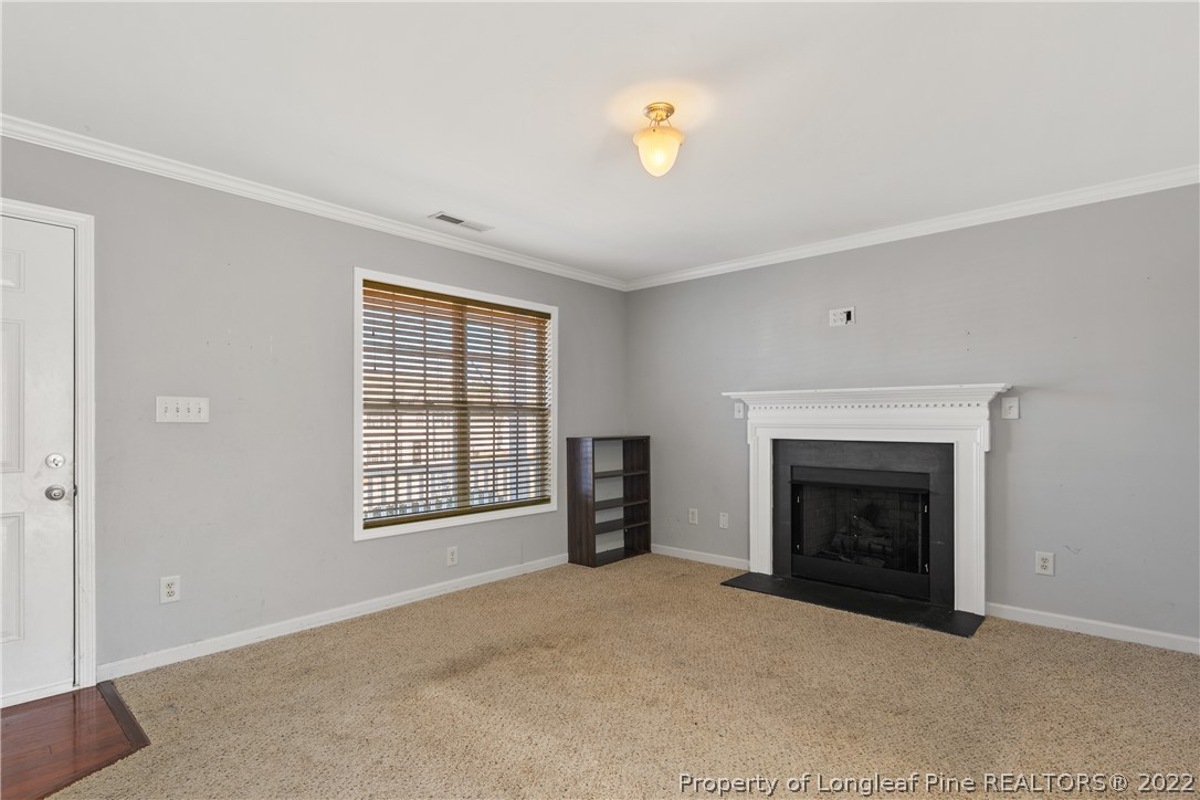 57 Pender Road Spring Lake, NC 28390 - Photo 8 of 50 an empty room with windows and fireplace