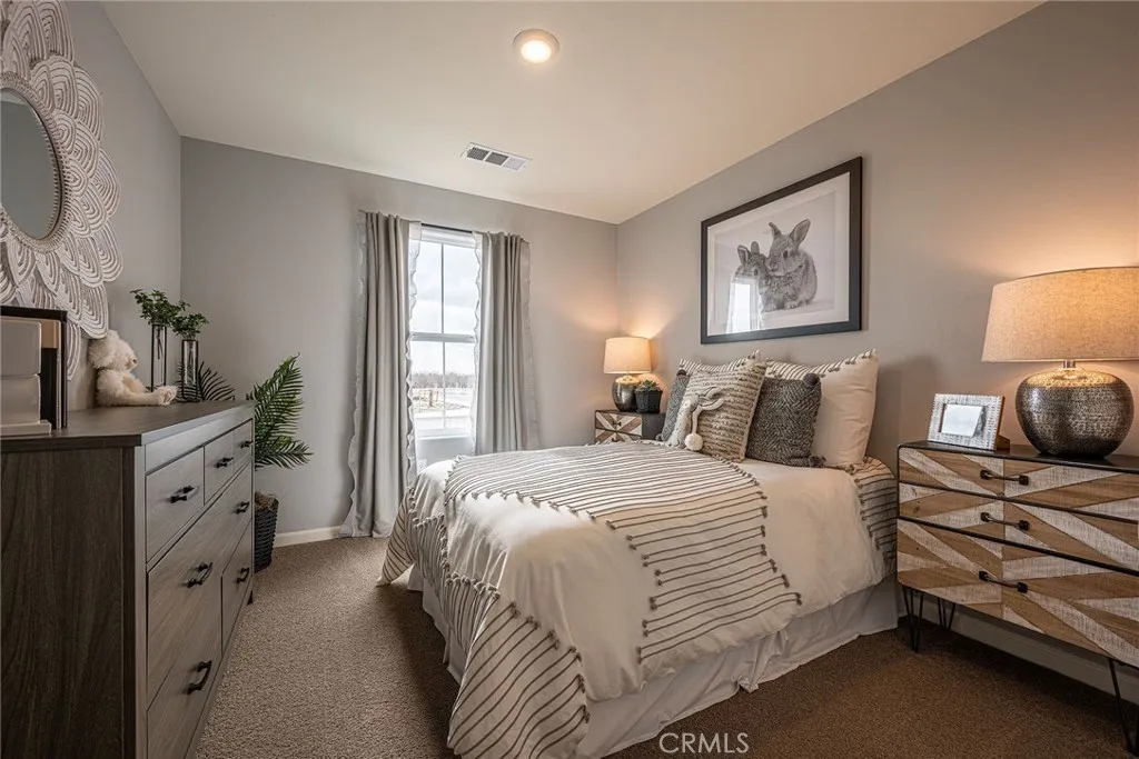 613 Marshall Lane, Unit 126 B2 Merced, CA 95340 - Photo 15 of 19 a bedroom with a bed and a window