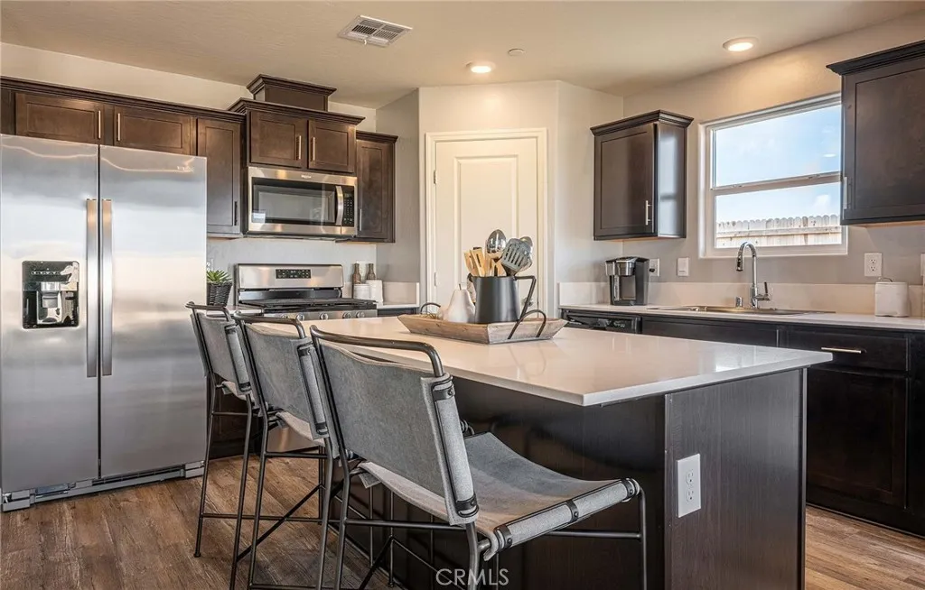 613 Marshall Lane, Unit 126 B2 Merced, CA 95340 - Photo 2 of 19 a kitchen with a sink stainless steel appliances and cabinets
