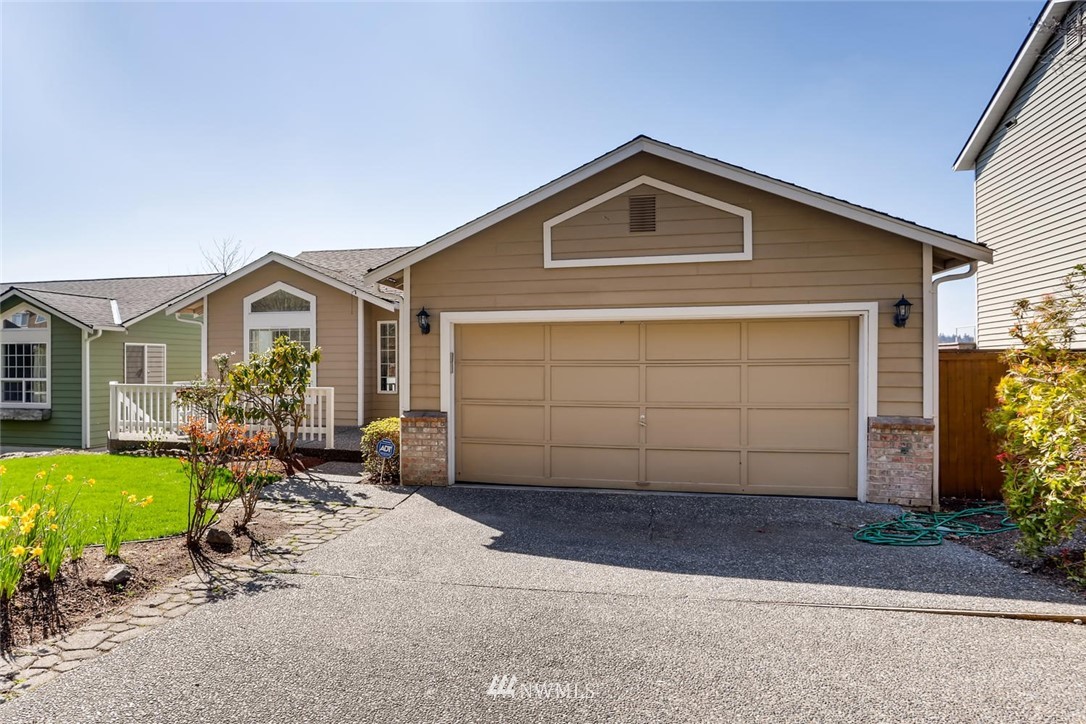 21022 25th Drive Southeast Bothell, WA 98021 - Photo 2 of 27 a front view of a house with a yard and garage