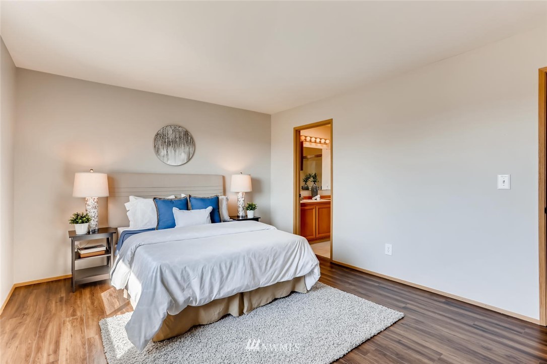 21022 25th Drive Southeast Bothell, WA 98021 - Photo 18 of 27 a bedroom with a bed and a lamp on table