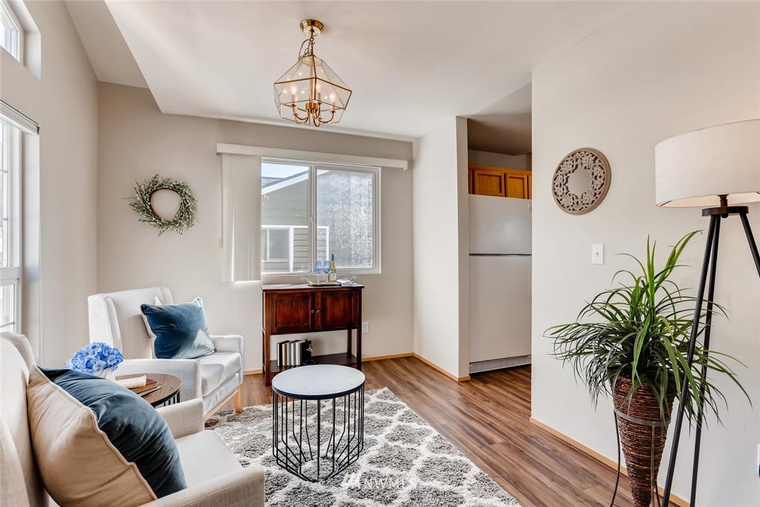 21022 25th Drive Southeast Bothell, WA 98021 - Photo 6 of 27 a living room with furniture a window and a chandelier