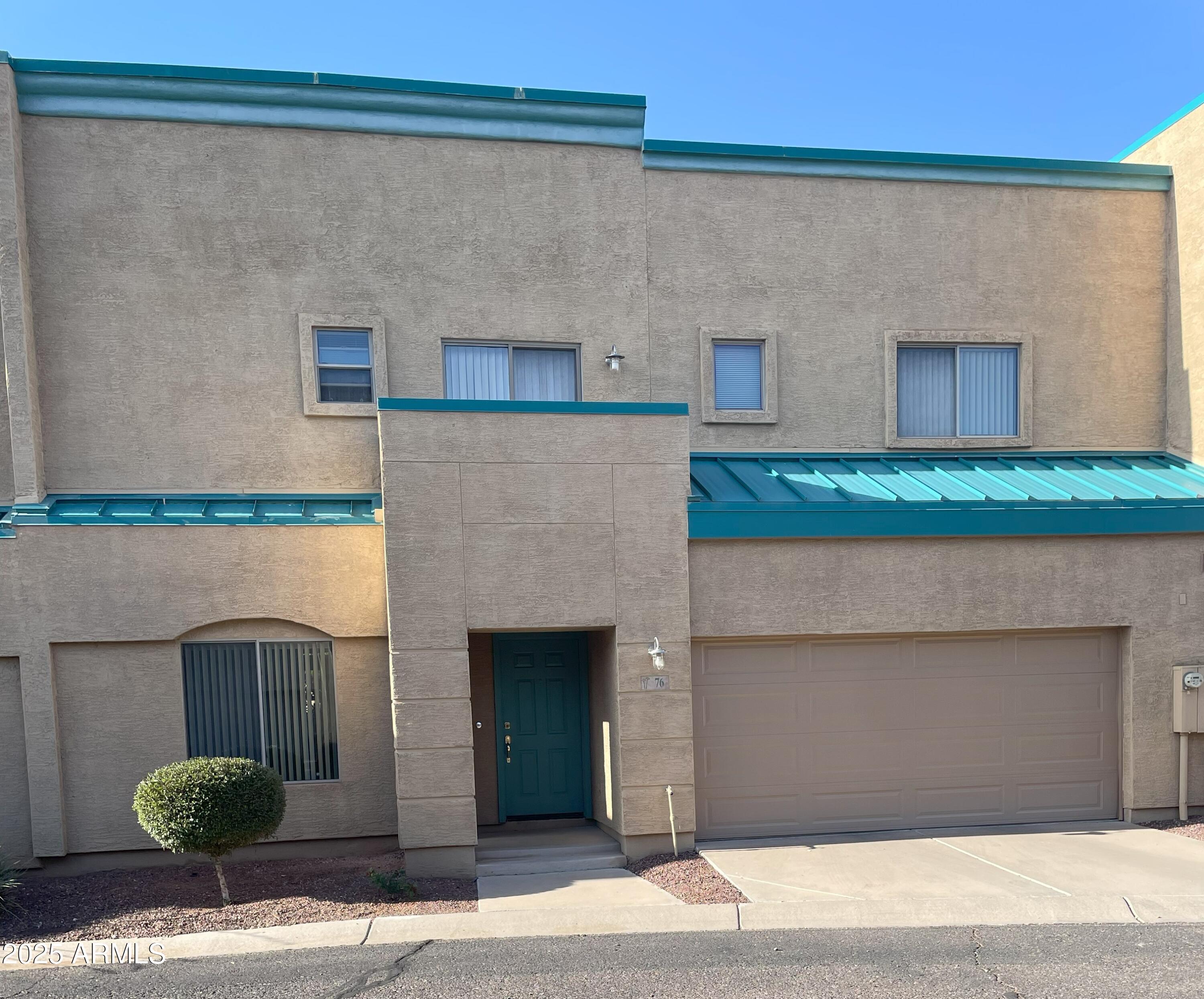 1015 South Val Vista Drive, Unit 76 Mesa, AZ 85204 - Photo 1 of 16 a front view of a house with garden