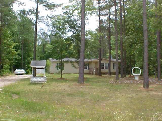 a green bench sitting in the middle of a yard